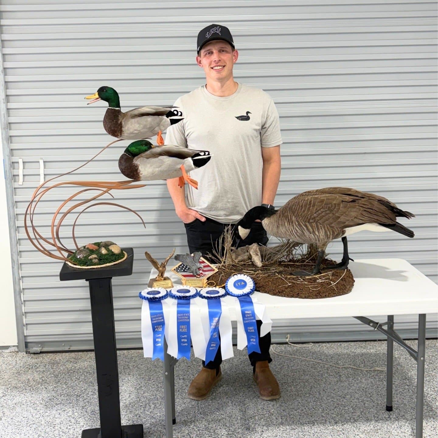 Alec Ferrin with award-winning mounts at the Idaho State Taxidermy Competition
